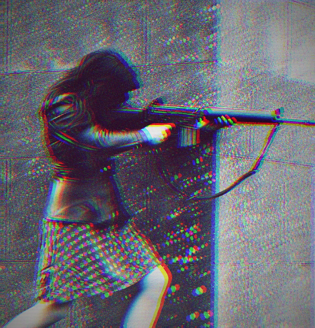 a dark-haired IRA fighter in a spotted skirt and a leather jacket points a rifle around the corner of a building. The photo, from the 1970s, is black and white but is distorted through RGB shift and scanlines.